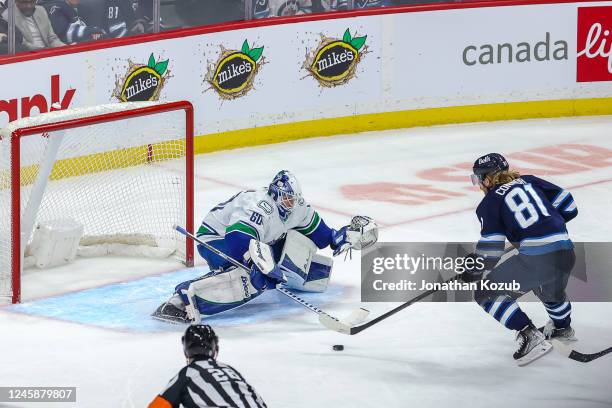 Goaltender Colin Delia of the Vancouver Canucks guards the net as Kyle Connor of the Winnipeg Jets breaks in on goal during third period action at...