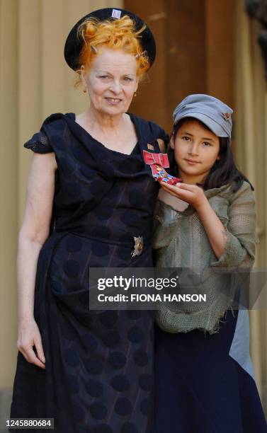 British Fashion designer Dame Vivienne Westwood poses her granddaughter Cora Corre for photographers after collecting her ensignia from the Prince of...