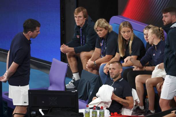 Britain team captain Tim Henman talks to players at the end of mens singles match of the United Cup tennis tournament between Australia's Jason...