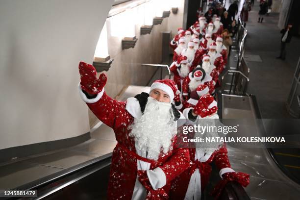 Employees of Moscow Metro dressed as Father Frosts take part in a Christmas and New Year flash mob for passengers in the Moscow underground on...