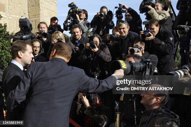 Italian Prime Minister Silvio Berlusconi and Russian President Dmitry Medvedev interact with a group of press photographers at Villa Madama in Rome...