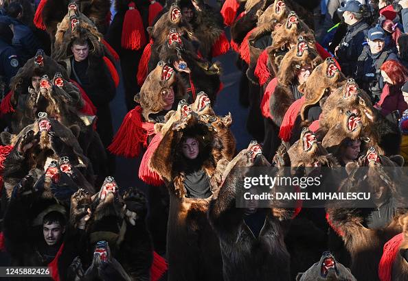Revellers wearing bearskin costumes march during the Bearskin Parade ...