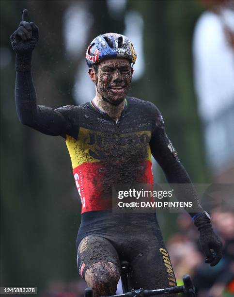 Belgian Wout Van Aert celebrates as he crosses the finish line at the end of the men's elite race of the cyclocross cycling event, race 6/8 during...