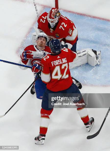 Gustav Forsling of the Florida Panthers checks Brendan Gallagher of the Montreal Canadiens to the ice in front of goaltender Sergei Bobrovsky at the...