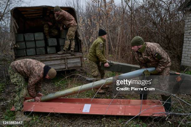 Soldiers of the 59th brigade of the Ukrainian Armed Forces unload missiles prior to firing grad missiles on Russian positions in Russia-occupied...