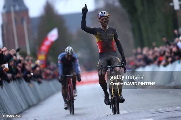 Belgian Wout Van Aert celebrates as he crosses the finish line at the end of the men's elite race of the cyclocross cycling event, race 6/8 during...