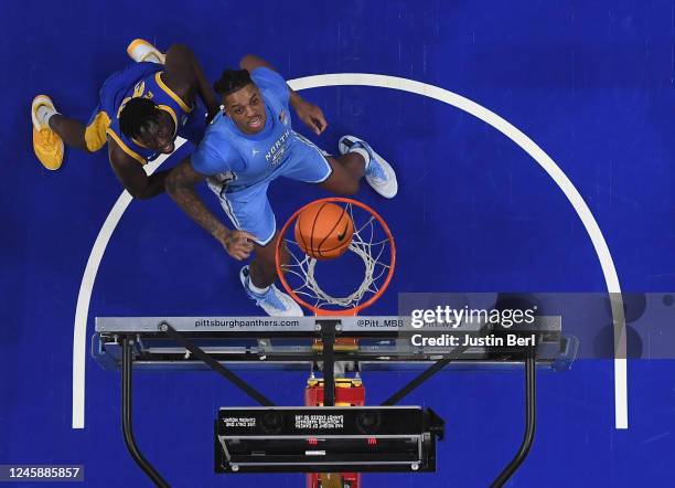 Armando Bacot of the North Carolina Tar Heels and Federiko Federiko of the Pittsburgh Panthers watch as a North Carolina Tar Heels basket goes into...