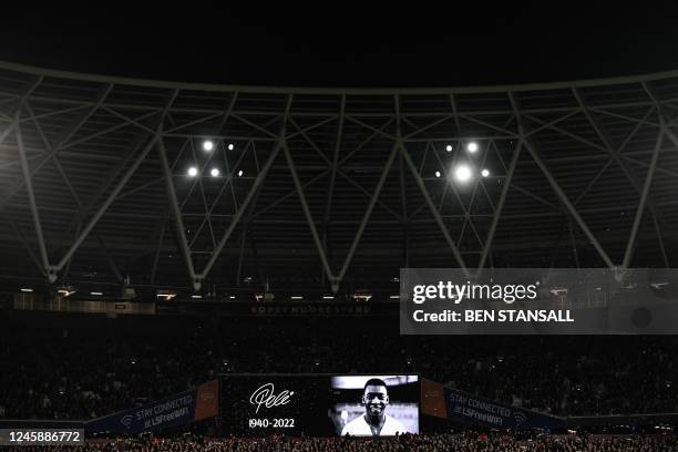 Members of the public, players and officials observe a minute's silence to honour Brazilian football legend Pele, who died on December 29, ahead of...