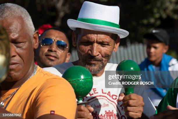 Members of the Playaz Inc. Minstrel troupe sing and dance as they practice at a school in Mitchells Plain near Cape Town, on December 30 ahead of the...