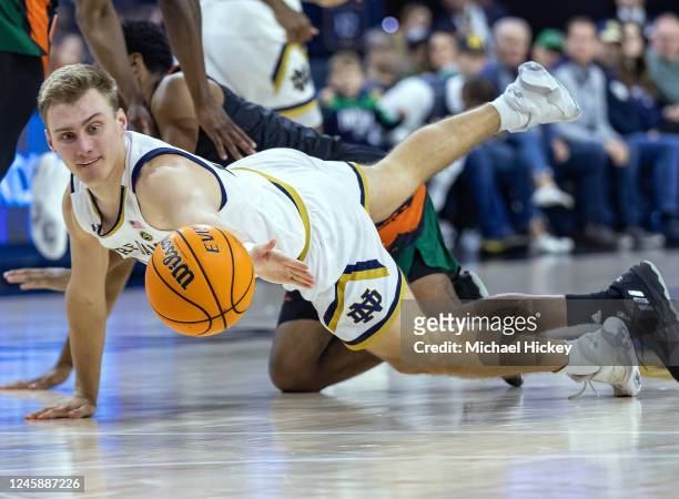 Dane Goodwin of the Notre Dame Fighting Irish dives for the loose ball during the first half against the Miami Hurricanes at Joyce Center on December...