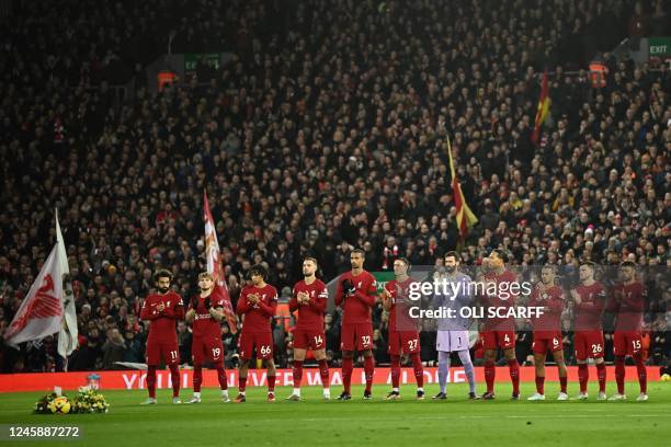 Players and officials observe a minute's silence to honour Brazilian football legend Pele, who died on December 29, and late former Liverpool's...