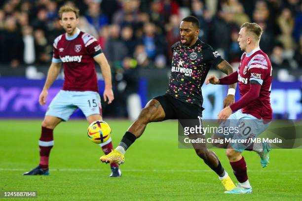 Ivan Toney of Brentford holds off the challenge from Jarrod Bowen of West Ham United during the Premier League match between West Ham United and...