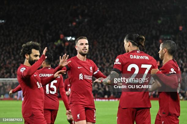 Liverpool's teammates celebrate the second owngoal scored by Leicester City's Belgian defender Wout Faes during the English Premier League football...