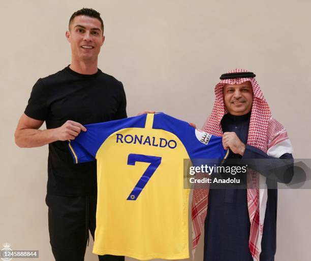 Portuguese football star Cristiano Ronaldo poses for a photo with the jersey after signing with Saudi Arabia's Al-Nassr Football Club in Riyadh,...