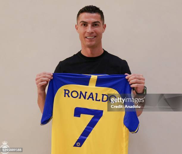 Portuguese football star Cristiano Ronaldo poses for a photo with the jersey after signing with Saudi Arabia's Al-Nassr Football Club in Riyadh,...