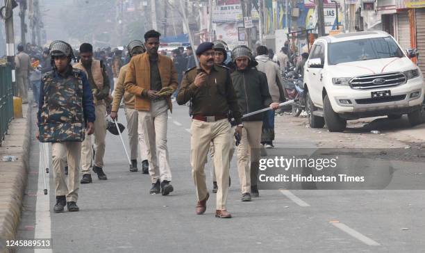 Police personnel seen trying to maintain law and order situation for the Crowds gathered outside of A.N. College as the counting of votes begins for...