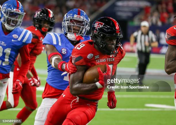 Mississippi Rebels safety Isheem Young reaches to tackle Texas Tech Red Raiders wide receiver Loic Fouonji in the second quarter during the TaxAct...