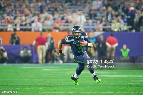 Seattle Seahawks quarterback Russell Wilson runs with the ball during Superbowl XLIX game between the Seattle Seahawks and the New England Patriots,...