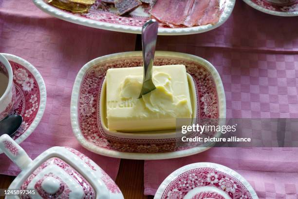 December 2022, Thuringia, Weimar: A started piece of butter in a porcelain butter dish. Photo: Soeren Stache/dpa