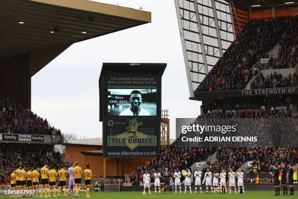 Players and officials observe a minute's applause to honour Brazilian football legend Pele, who died on December 29, ahead of the English Premier...