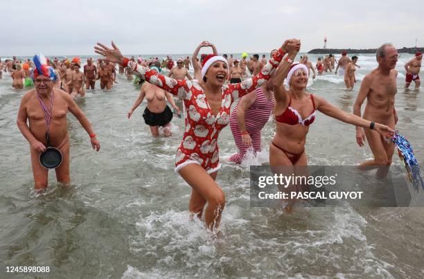 Graphic content / People take part in a traditional sea bath to mark the New Year's celebrations on a nudist beach in Le Cap d'Agde, southern France,...