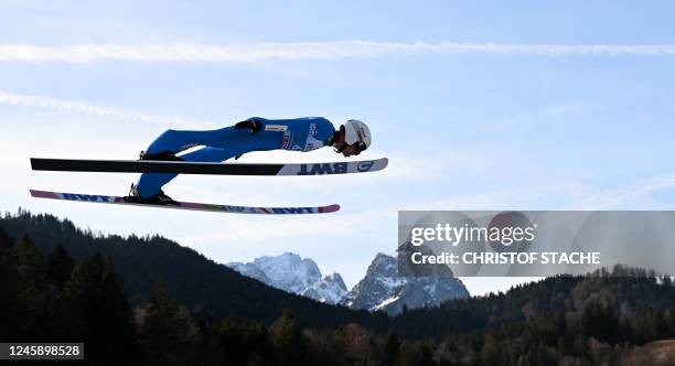 Poland's Piotr Zyla soars through the air in front of the Zugspitz mountain and the Waxenstein mountain during the practice session of the Four Hills...