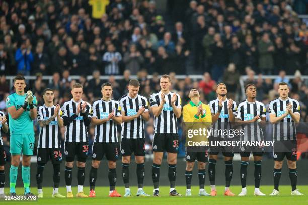 Newcastle players observe a minute's applause to honour Brazilian football legend Pele, who died on December 29, ahead of the English Premier League...