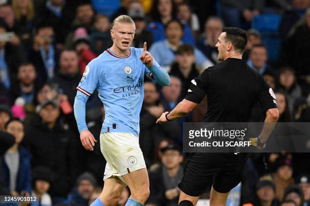 Manchester City's Norwegian striker Erling Haaland gestures to English referee Andrew Madley before receiving a yellow card for a foul during the...