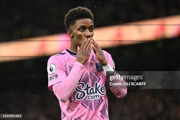 Everton's English striker Demarai Gray celebrates after scoring their first goal during the English Premier League football match between Manchester...