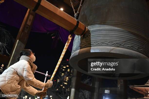 Young girl rings the bell 108 times as she takes part to the Joya no kane at Zojoji temple during the New Year celebrations in Tokyo, Japan on...