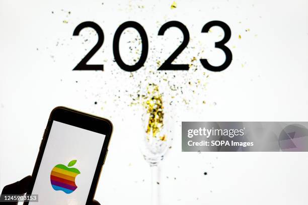 In this photo illustration an Apple logo seen displayed on a smartphone.