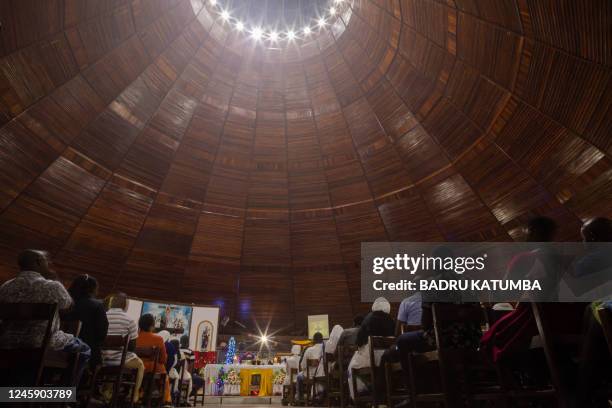 Catholic faithfuls gather inside the Basilica of the Uganda Martyrs to pray after receiving news about the death of former Pope Emeritus Benedict XVI...