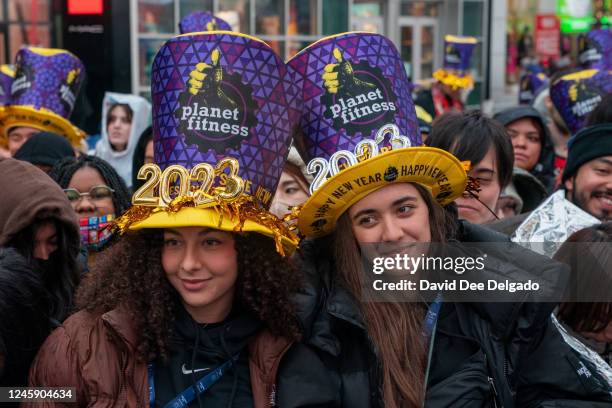 Revelers wait in the rain at Times Square for the midnight ball drop for the New Year's Eve celebration on December 31, 2022 in New York City....