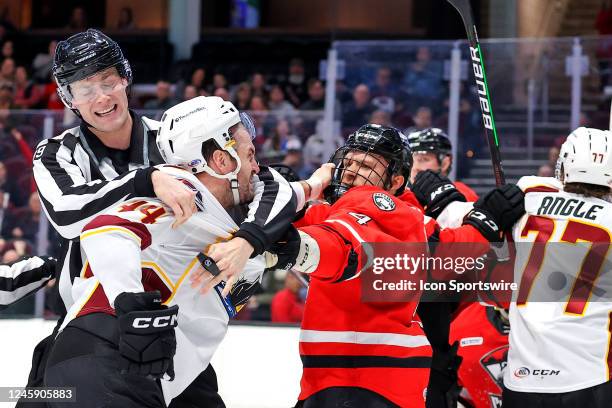 Cleveland Monsters left wing Brett Gallant and Charlotte Checkers defenceman John Ludvig fight during the second period of the American Hockey League...