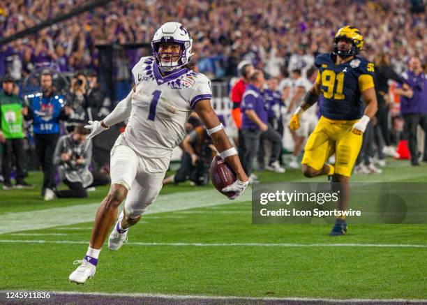 Horned Frogs wide receiver Quentin Johnston runs the ball into the end zone for a touchdown during the Vrbo Fiesta Bowl between the Michigan...