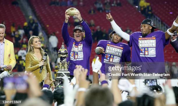 Head coach Sonny Dykes holds up the Fiesta Bowl trophy after defeating Michigan, 51-45, in the Vrbo Fiesta Bowl at State Farm Stadium on Saturday,...