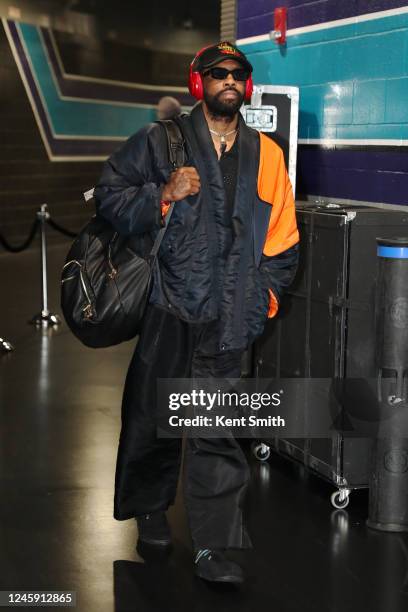 Kyrie Irving of the Brooklyn Nets arrives to the arena before the game against the Charlotte Hornets on December 31, 2022 at Spectrum Center in...