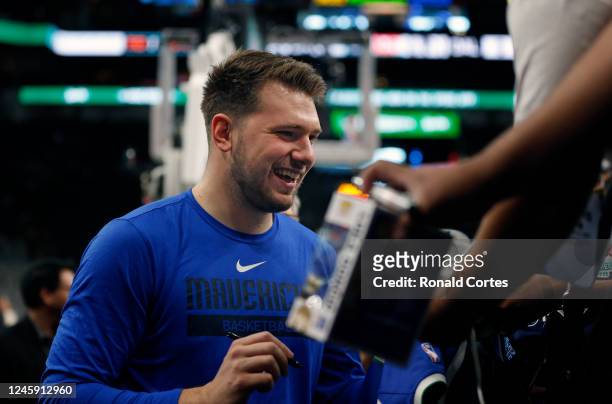 Luka Doncic of the Dallas Mavericks signs autographs before the start of their game against the San Antonio Spurs at AT&T Center on December 31, 2022...