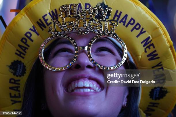 Reveler at Times Square waits for the midnight ball drop at the New Year's Eve celebration on December 31, 2022 in New York City. Revelers return to...