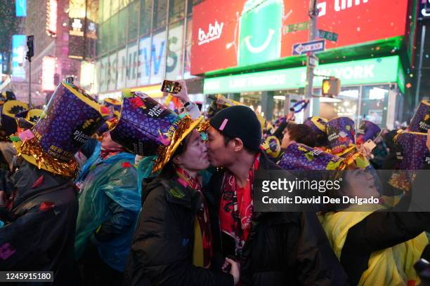 Couple kisses at Times Square during New Year celebrations on January 1, 2023 in New York City. Revelers return to a full scale event after two years...