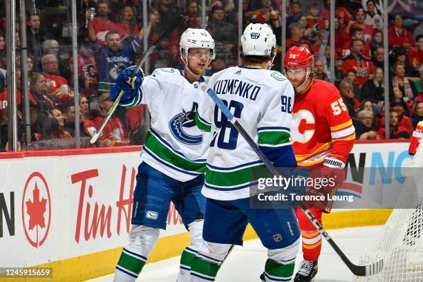 Elias Pettersson of the Vancouver Canucks celebrates with teammates after a goal against the Calgary Flames at Scotiabank Saddledome on December 31,...