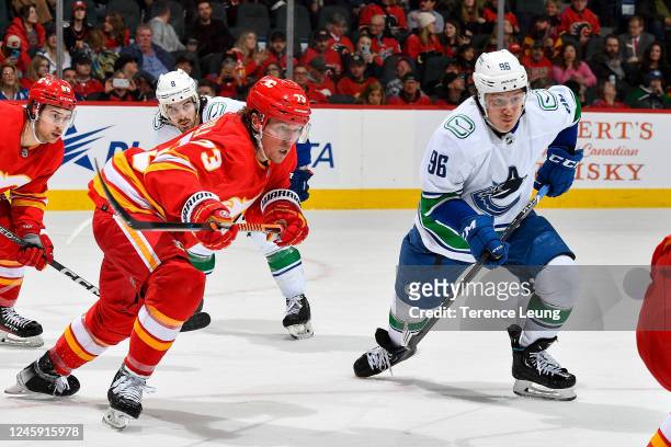 Andrei Kuzmenko of the Vancouver Canucks battles against Tyler Toffoli of the Calgary Flames at Scotiabank Saddledome on December 31, 2022 in...