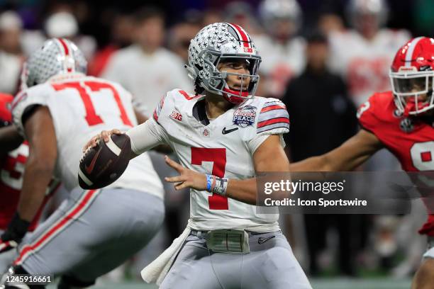 Ohio State Buckeyes quarterback C.J. Stroud drops back to pass during the college football playoff semifinal game between the University of Georgia...