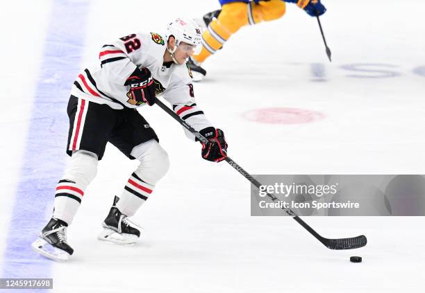 Blackhawks defenseman Caleb Jones controls the puck as he skat4es up the ice during a NHL game between the Chicago Blackhawks and the St. Louis Blues...