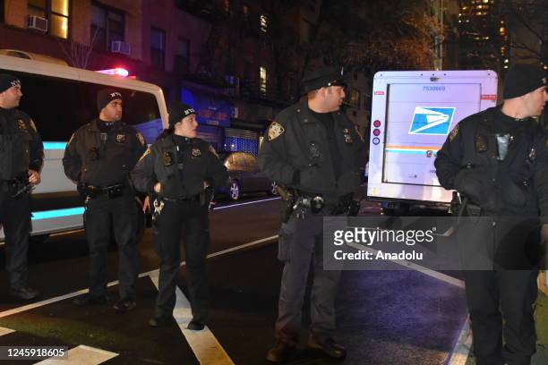 Police officers stand guard on a road after a 19-year-old assailant attacked three NYPD officers with a machete near Times Square during the new year...