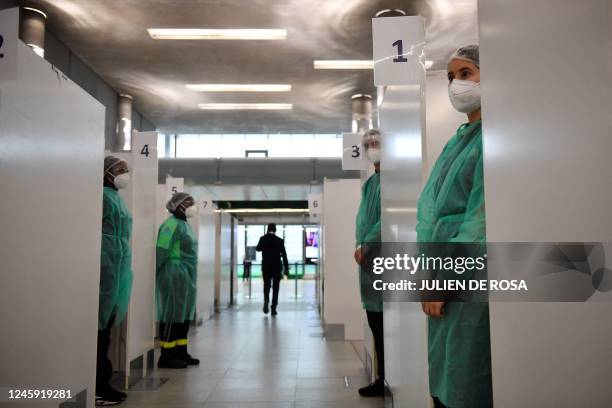 Medical staff of the COVID-19 testing centre of the Paris-Charles-de-Gaulle airport wait for travellers from China in Roissy, outside Paris, on...