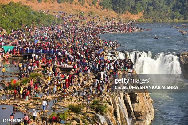Visitors crowd on the New Year's Day around Marble Rocks Waterfall on Narmada river in Bhedaghat on the outskirts of Jabalpur on January 1, 2023.