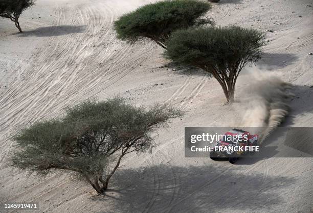 Toyota's driver Nasser Al-Attiyah of Qatar and his co-driver Mathieu Baumel of France compete during Stage 1 of the Dakar 2023 around Sea Camp by the...