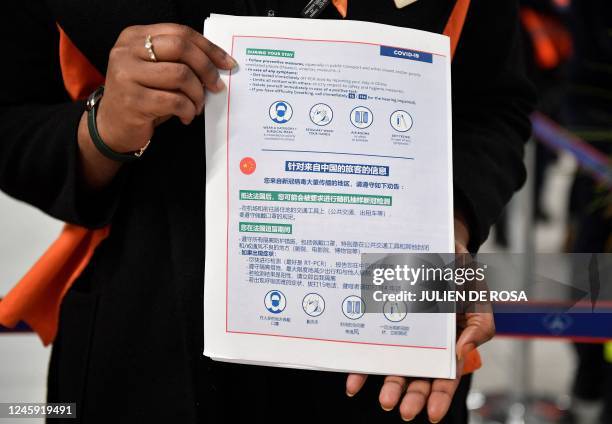 This picture shows a COVID-19 preventive measures information document provided to the passengers of a flight from China at the...