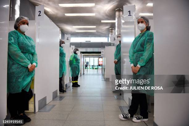 Medical staff of the COVID-19 testing centre of the Paris-Charles-de-Gaulle airport wait for travellers from China in Roissy, outside Paris, on...